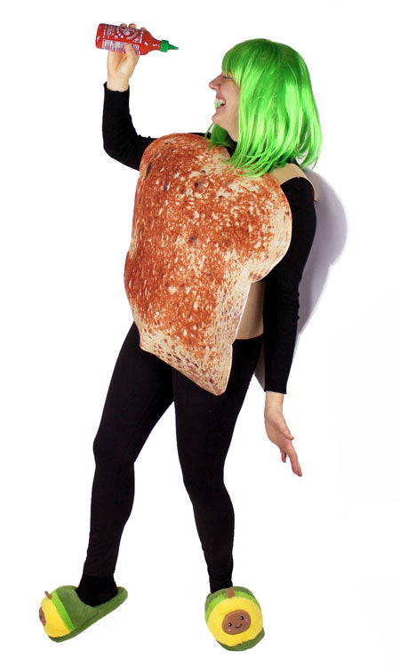 Woman wearing green wig, large bread shaped suit, and avocado slippers.  She holds a bottle of hot sauce.