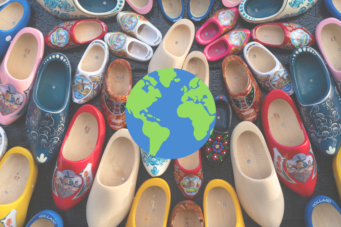 Picture of a collection of wooden shoes with a world map in the middle