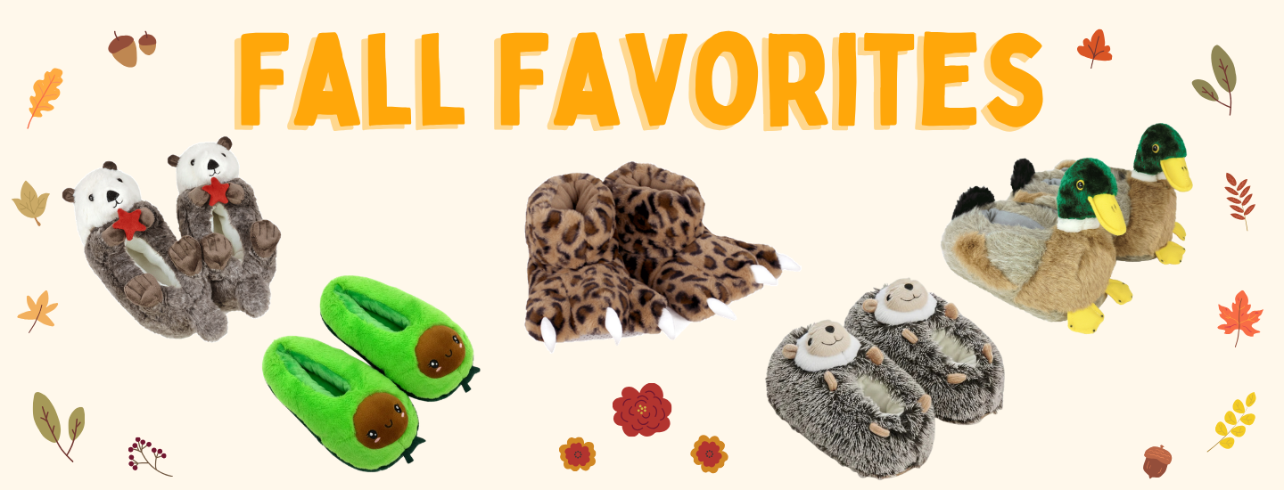 A promotional banner with the text 'FALL FAVORITES' on a cream background, surrounded by plush slippers. The products shown include otter slippers, avocado slippers, leopard paw slippers, hedgehog slippers, and mallard duck slippers. 