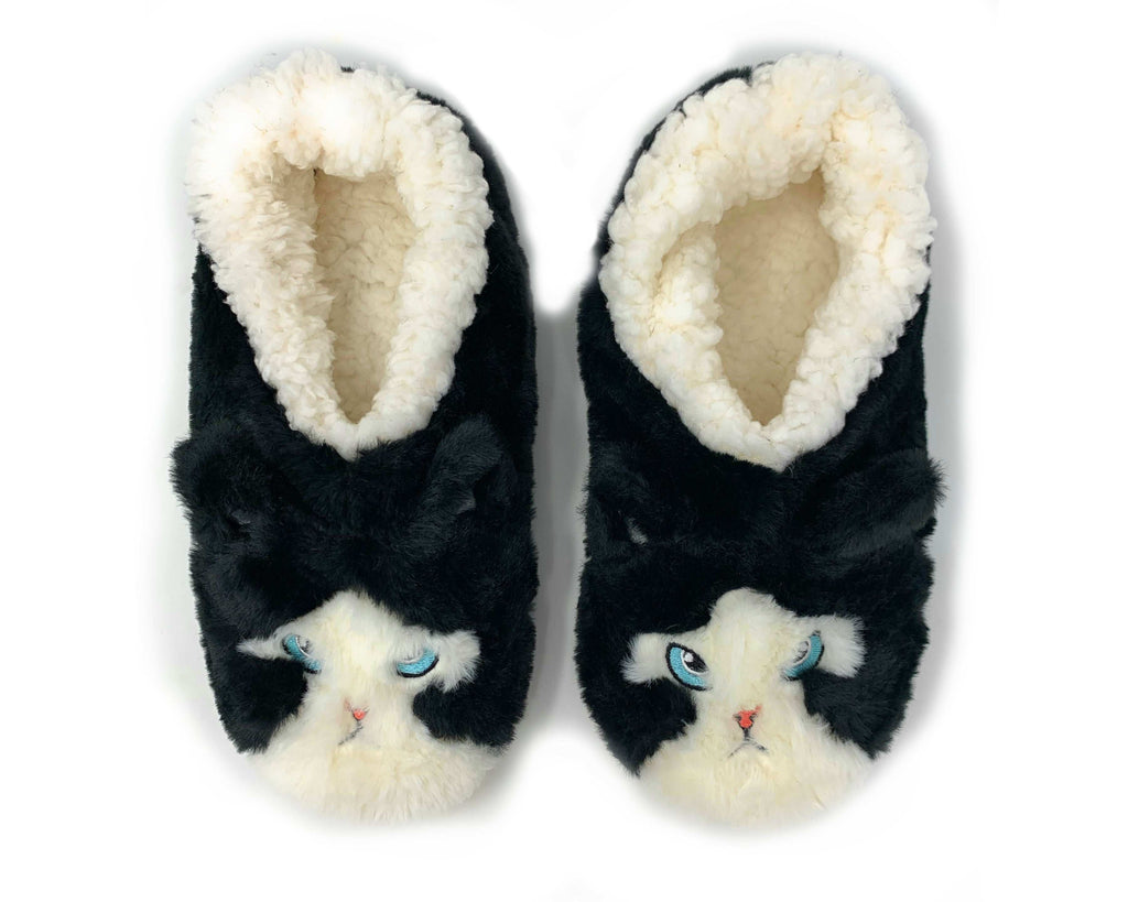 Pair of black slippers with white fur lining and cat face design on a white background