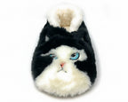 A novelty plush slipper shaped like a cat's face, featuring black and white faux fur with embroidered blue eyes and a small pink nose, shown on a plain white background.