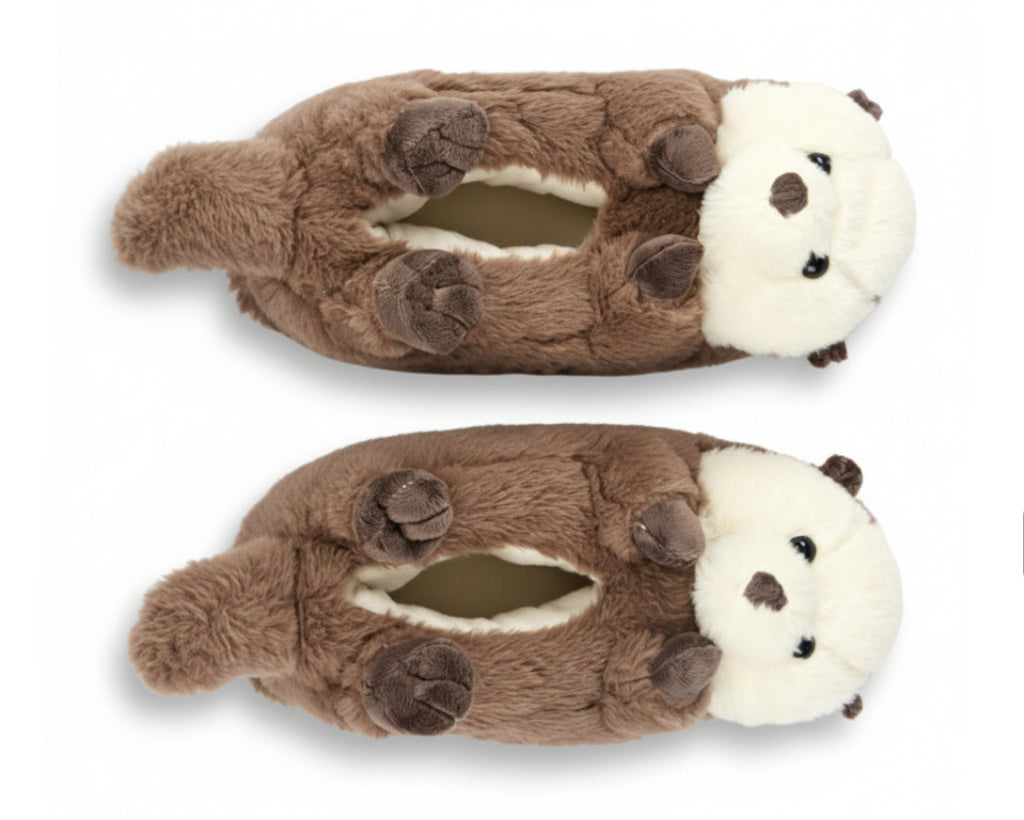 A pair of plush otter-shaped slippers in brown and cream white, shown from a top-down view on a plain white background.