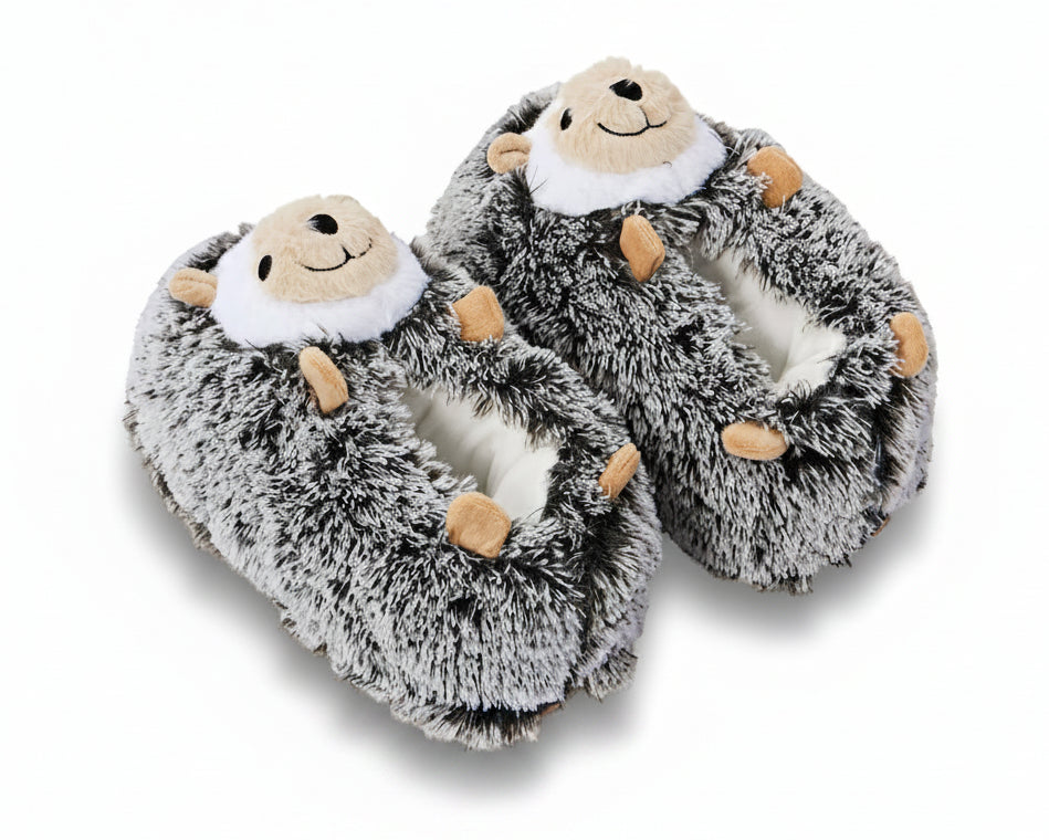 A pair of plush hedgehog slippers with gray and white faux fur, tan paws, and a smiling face on the top, shown on a white background.