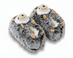 A pair of plush hedgehog slippers with gray and white faux fur, tan paws, and a smiling face on the top, shown on a white background.