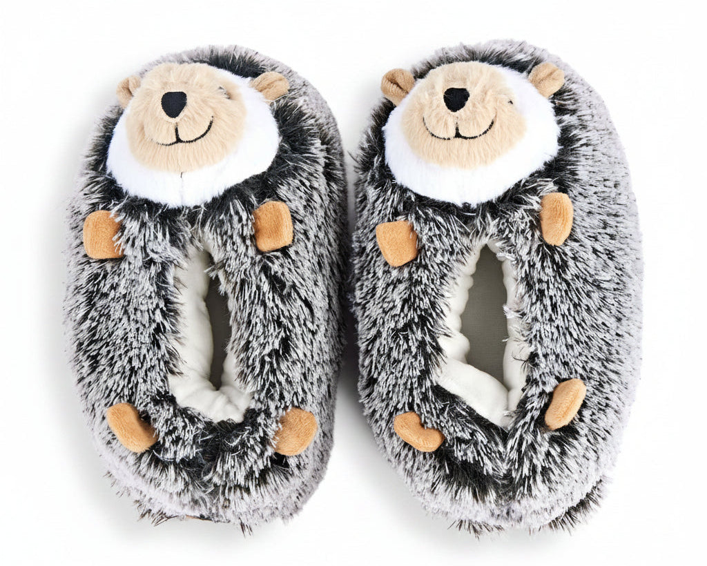 A pair of plush hedgehog slippers in gray and white faux fur with tan accents on the face and paws, shown on a plain white background.