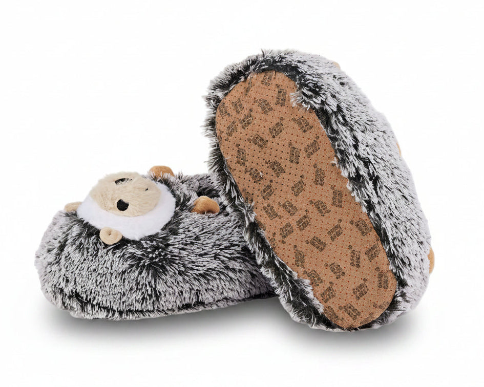 A pair of plush hedgehog slippers in gray and white faux fur, with one slipper turned to show the brown non-slip sole.