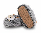A pair of plush hedgehog slippers in gray and white faux fur, with one slipper turned to show the brown non-slip sole.