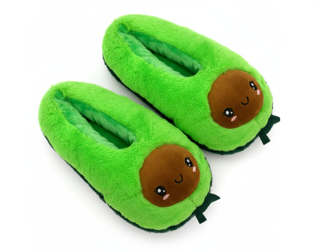 A pair of plush avocado-themed slippers in bright green with a cute cartoon face on the front and small green leaf details at the bottom, shown on a plain white background.