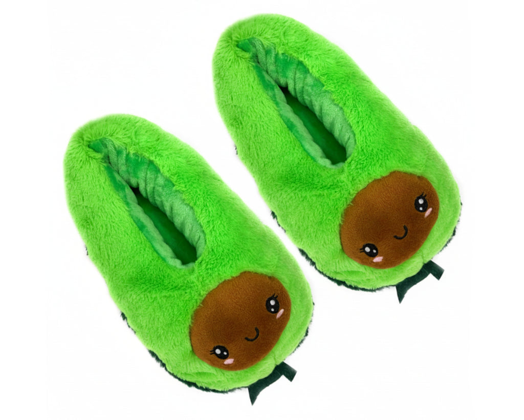 A pair of plush avocado-themed slippers in bright green with a cute cartoon face on the front and small green leaf details at the bottom, shown on a plain white background.
