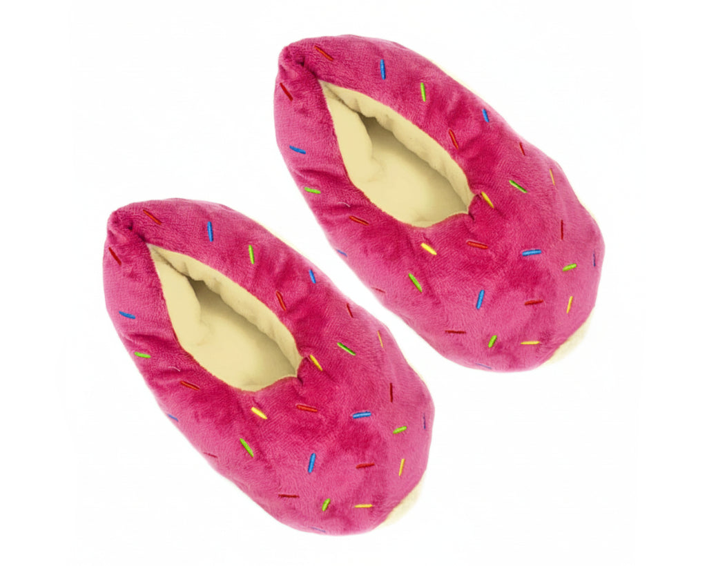 A pair of plush donut-shaped slippers in bright pink with multicolored sprinkle details and a cream-colored lining, shown against a plain white background.