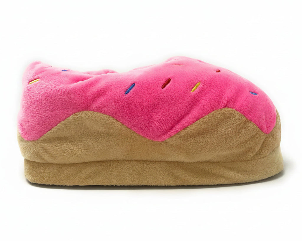 A plush donut-shaped slipper with bright pink frosting, colorful embroidered sprinkles, and a tan pastry-like base, photographed on a clean white background.