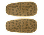 Pair of slippers seen from the bottom, showing faux suede soles with non-slip grips and a repeating brand name printed in black