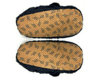 Pair of black bear slippers shown upside-down so that soles and non-slip grips are visible on a white background