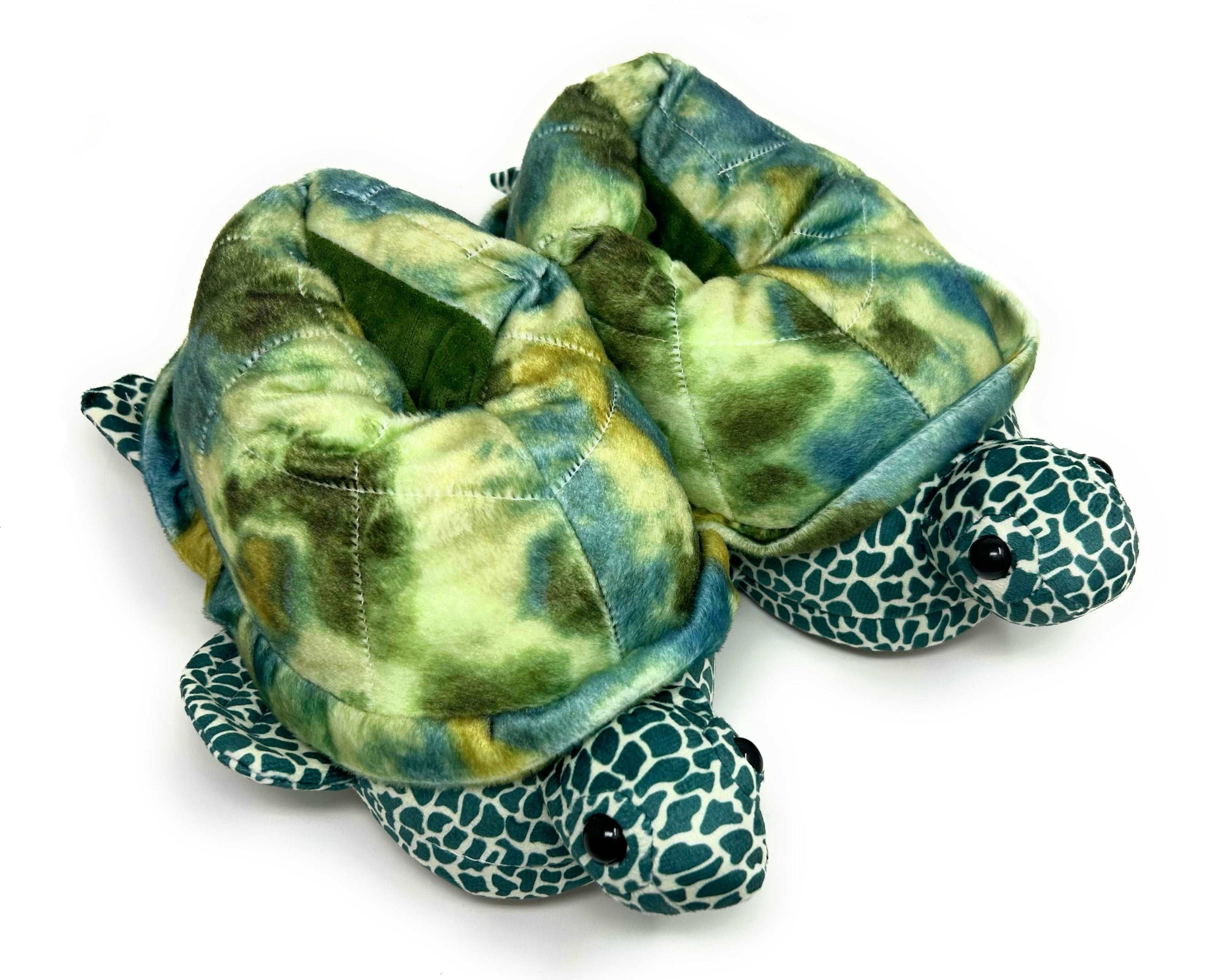 Turtle-shaped slippers with green and blue pattern on a white background