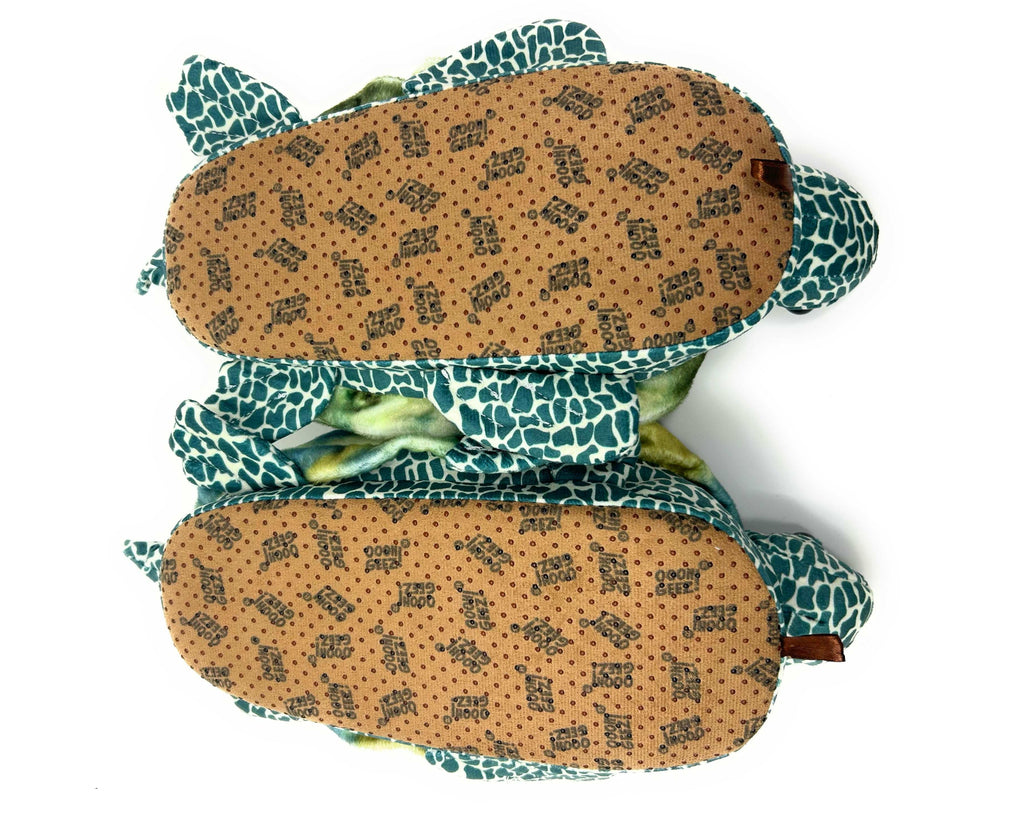 Bottom view of pair of plush Sea Turtle slippers, showing faux suede soles with non-slip grips