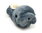 Plush manatee slipper on a white background