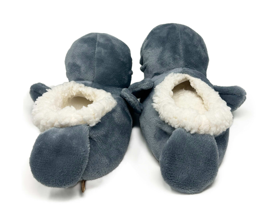 Pair of blue-gray manatee slippers with white interior on a white background