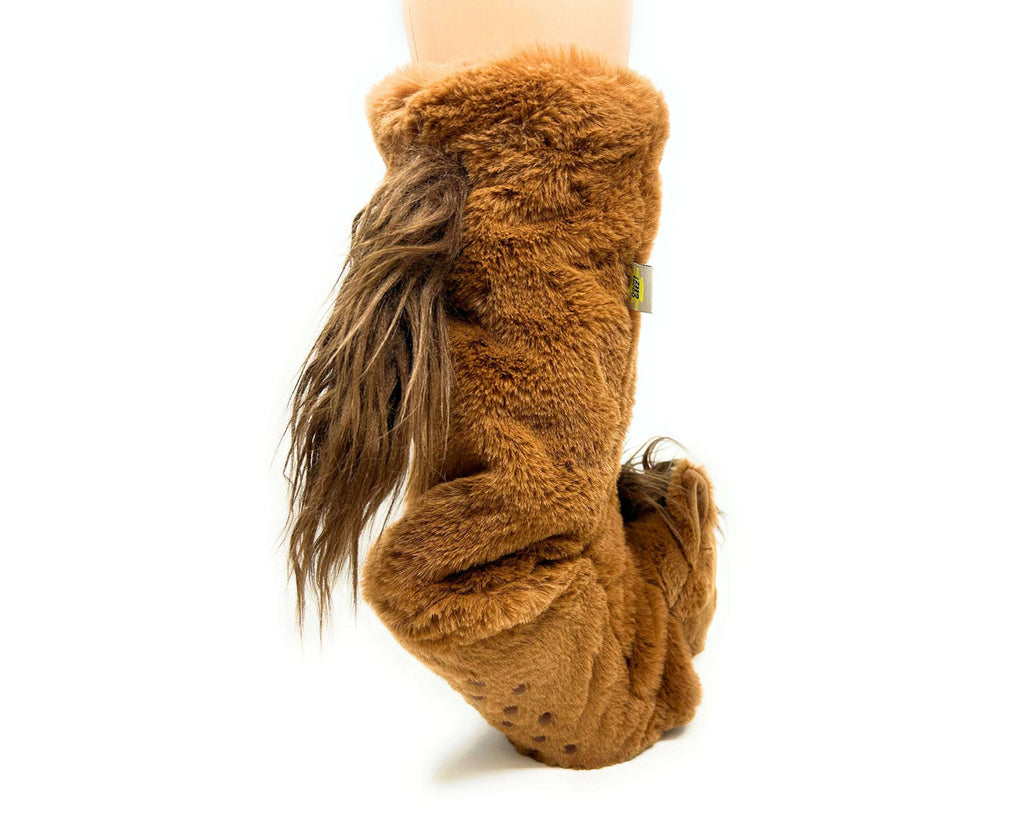 Brown fuzzy horse sock slippers worn by a person on a white background