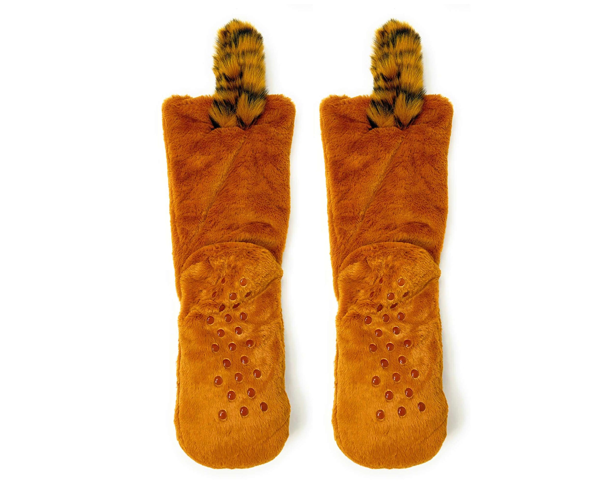 A pair of plush slipper boots in a warm rust-orange color, featuring textured grip dots on the soles and fuzzy animal-print tails. 