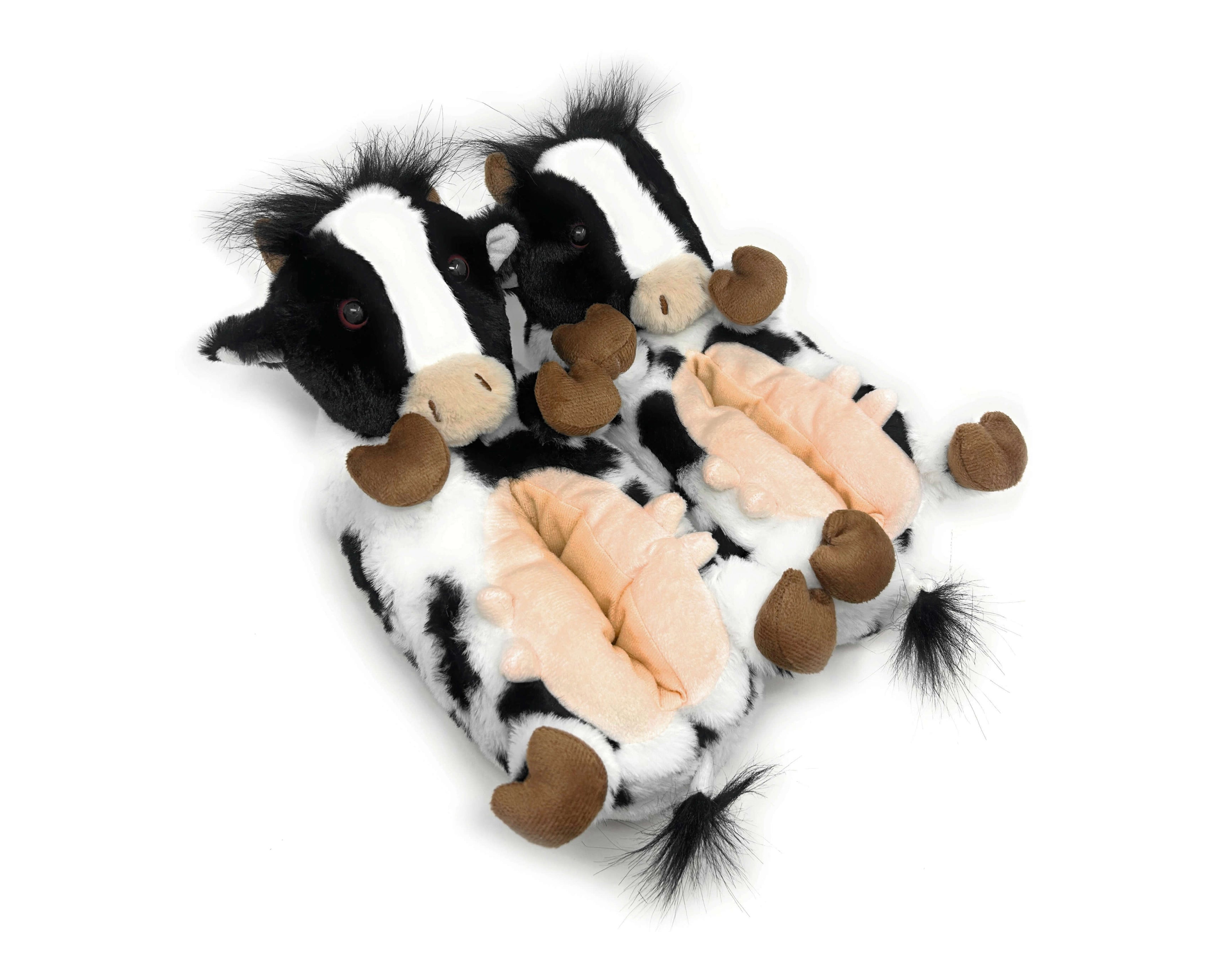 Plush cow slippers with brown feet on a white background