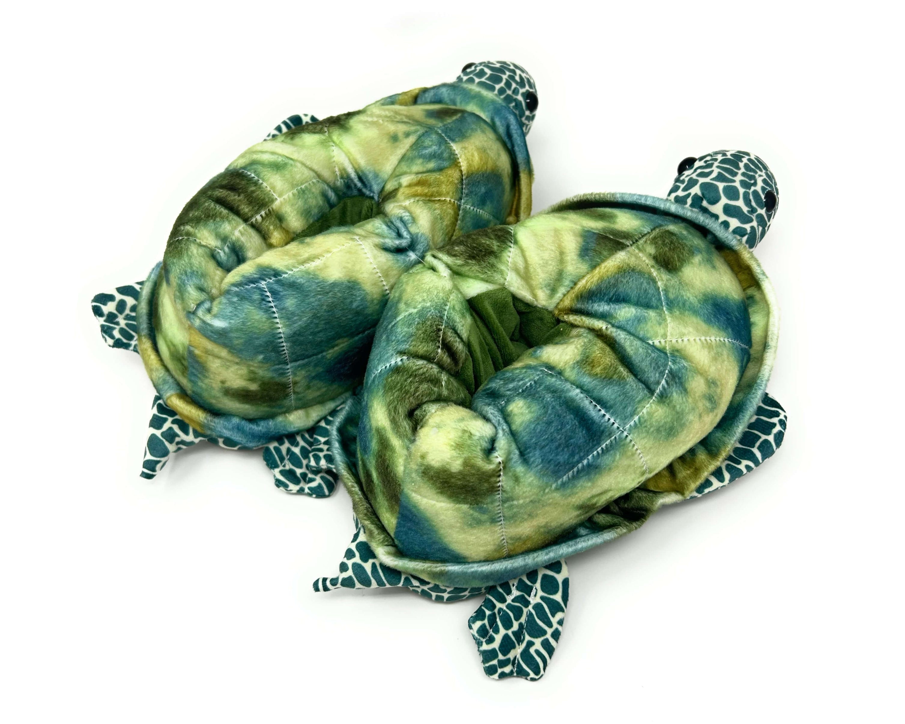 Two green plush turtle slippers on a white background