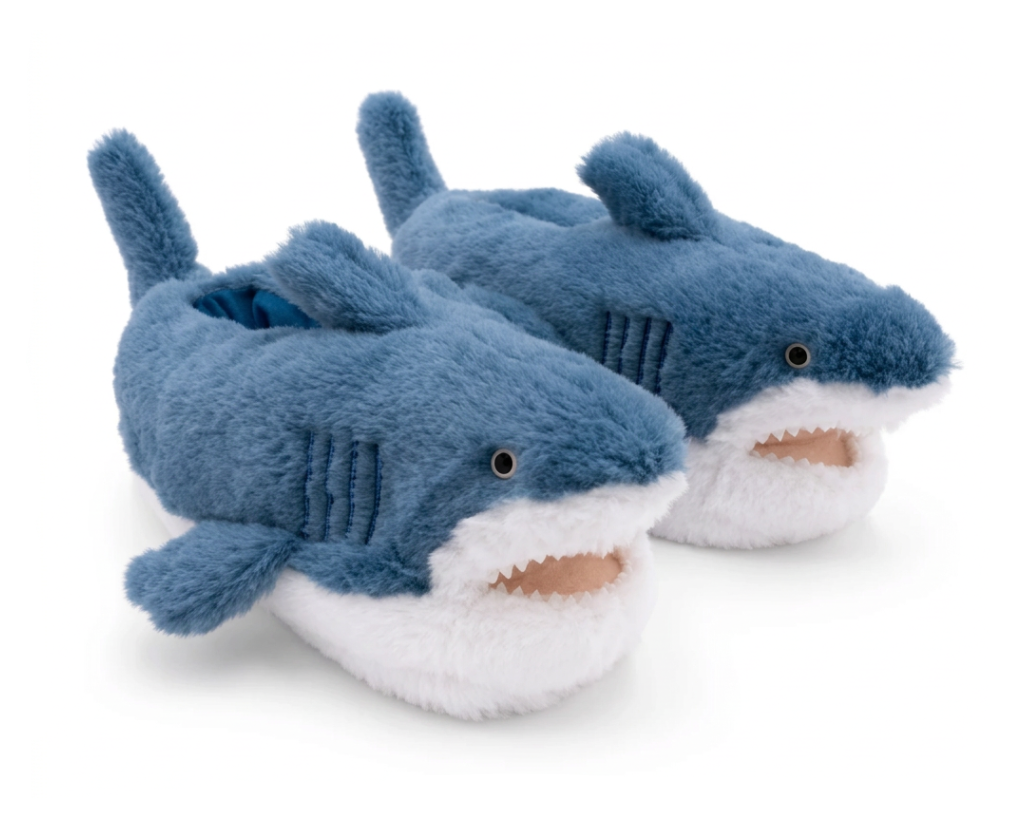 A pair of plush shark-shaped slippers in blue and white, photographed on a clean white background.