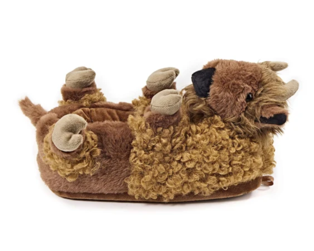 Plush bison slipper seen from the side, with brown faux fur, tails, horns, ears, and hooves