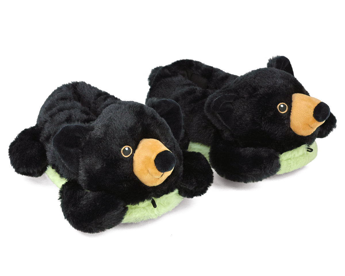 Pair of black bear slippers with green sole on a white background