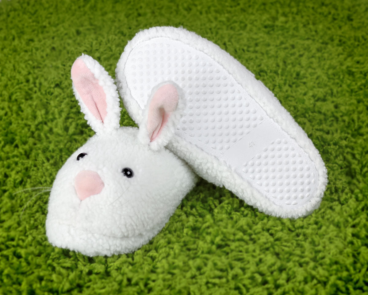 White bunny slippers on a green carpet
