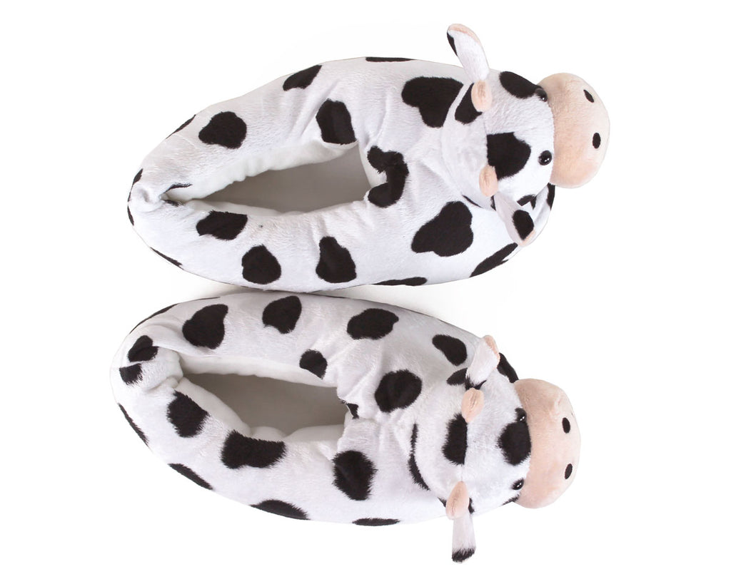 Pair of cow-patterned slippers on a white background, seen from above