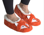 A pair of plush orange fox slippers with white faux-fur trim, shown being worn on a person's feet against a plain white background.