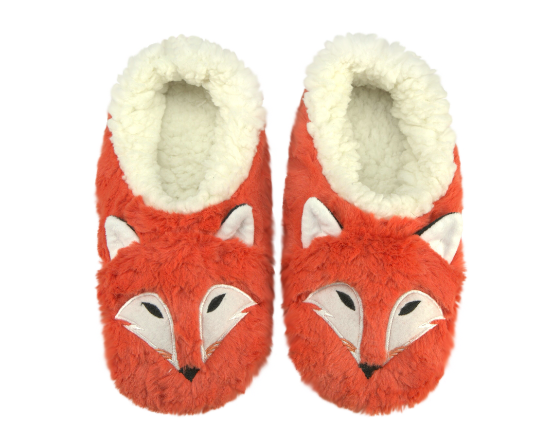 Pair of orange fox slippers with white ears and a faux shearling cream colored lining on a white background