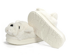 A pair of plush white slippers shaped like bulldogs, shown on a clean white background with one slipper standing upright to display the sole.
