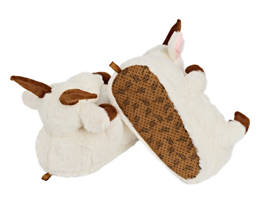 Pair of plush goat slippers with one slipper turned upside down to show faux suede sole with non-slip grips.