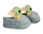 Side view of plush slippers shaped like the green Grogu character with big ears on a white background