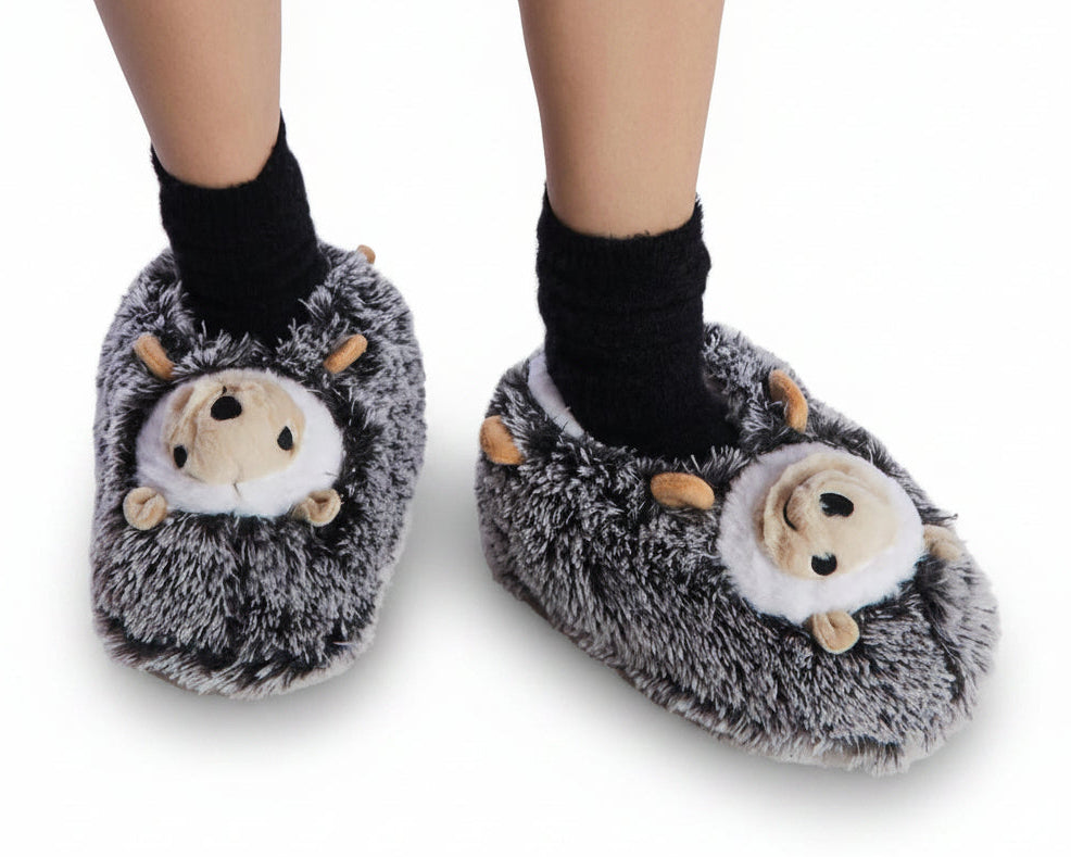 Hedgehog-shaped slippers worn by a person on a plain background