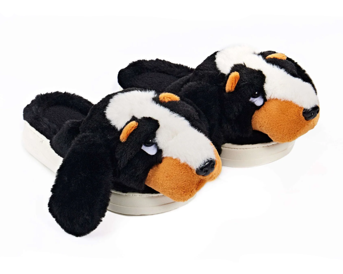 Pair of plush hound dog slippers with brown, white and black plush, eyes and noses, and molded soles. 