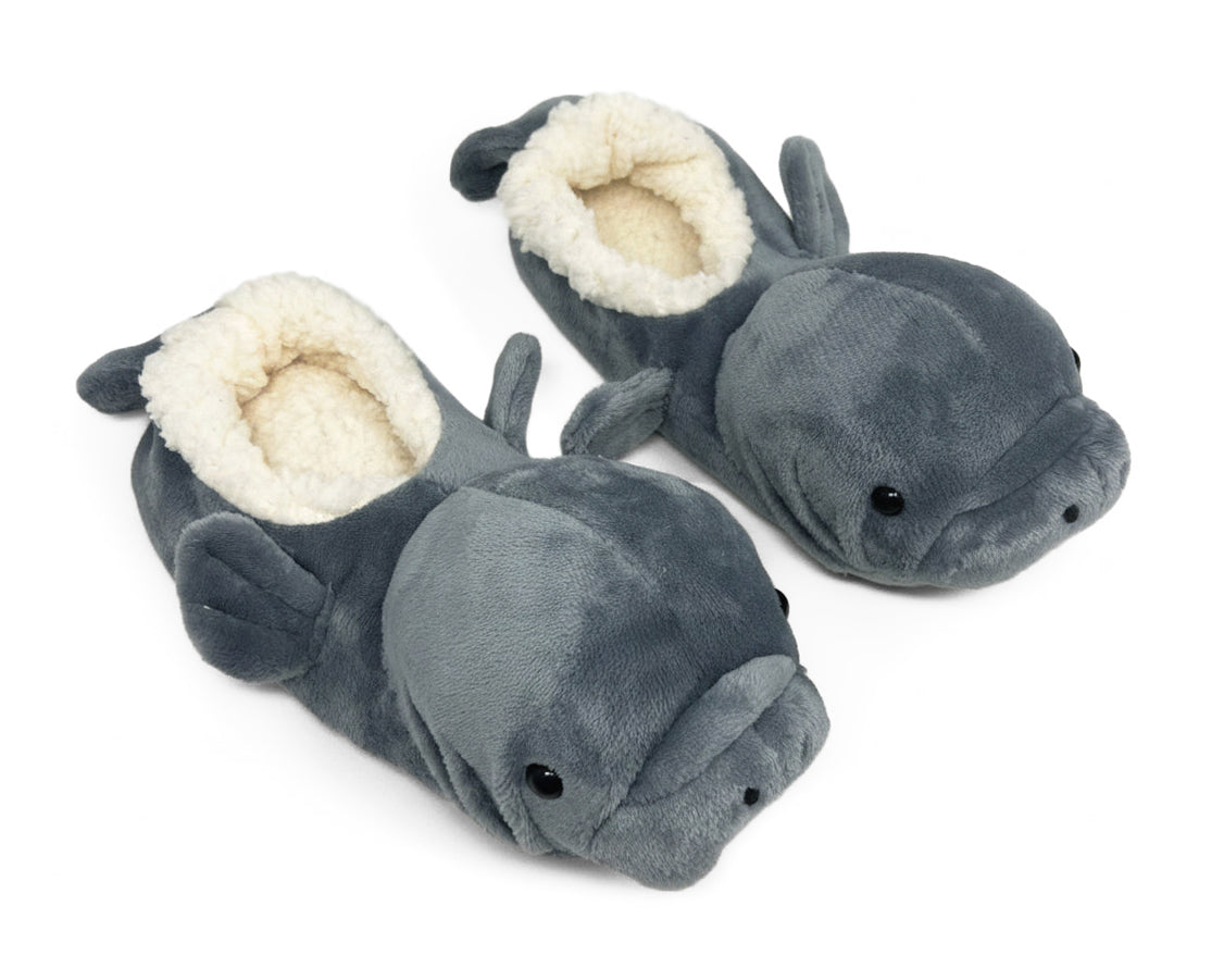 Pair of kids manatee slippers with dark gray plush, fins, tails and faux shearling linings on a white background