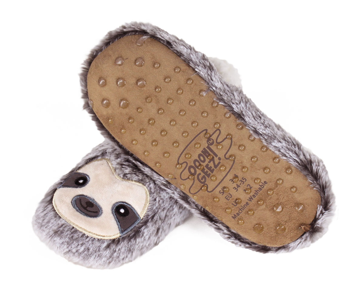 A pair of plush fuzzy slippers shaped like sloths, with one slipper showing the brown textured footbed and the other showing the gray faux-fur exterior and sloth face.