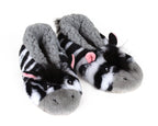 Pair of plush zebra sock slippers for kids with black and white striped plush, pink ears, gray noses, and gray fluffy linings.