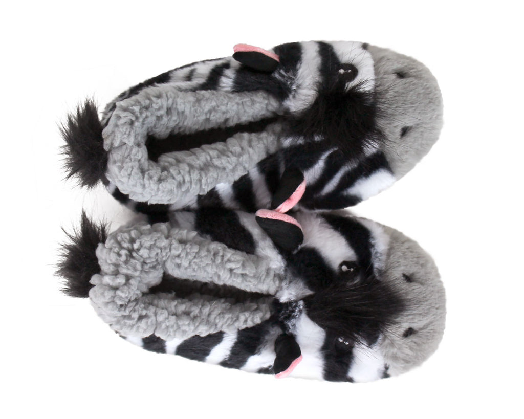 A pair of plush zebra-themed slippers with black and white striped bodies, gray fluffy ears, and small pink inner-ear accents, shown on a plain white background.