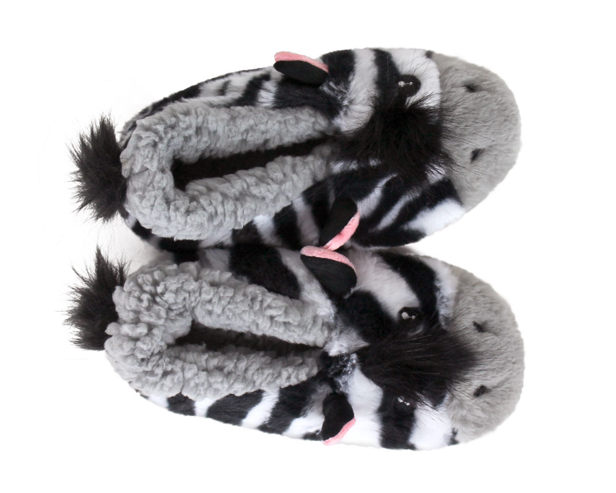 A pair of plush zebra-themed slippers with black and white striped bodies, gray fluffy ears, and small pink inner-ear accents, shown on a plain white background.