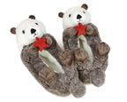 Pair of plush slippers shaped like otters holding red starfish on a white background