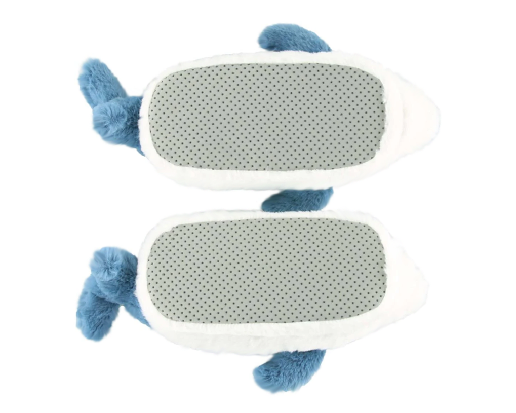 Bottom side of a pair of plush shark slippers, showing non-slip grips on soles.