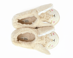 Pair of beige bunny slippers with long ears and embroidered faces on a white background, seen from above