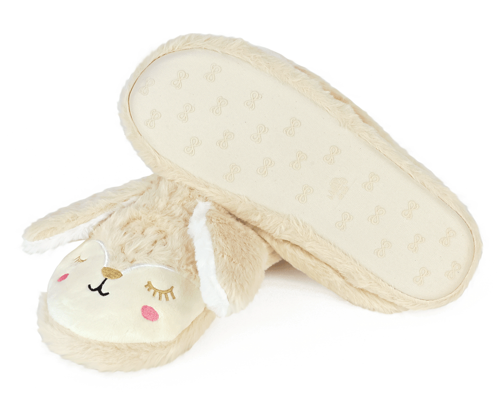 Pair of beige bunny slippers with long ears and embroidered faces on a white background, one slipper is turned upside down to show the non-slip sole