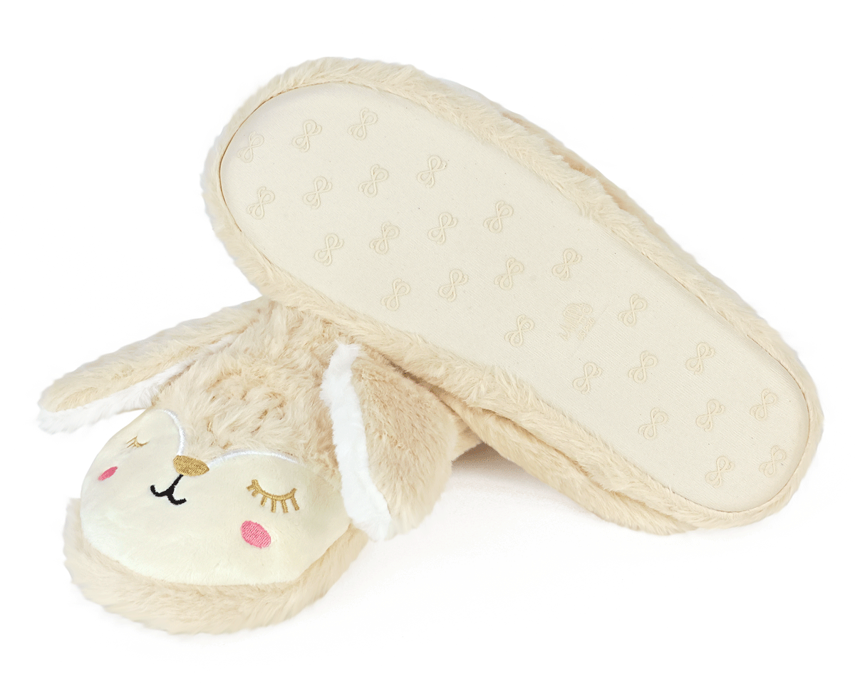 Pair of beige bunny slippers with long ears and embroidered faces on a white background, one slipper is turned upside down to show the non-slip sole